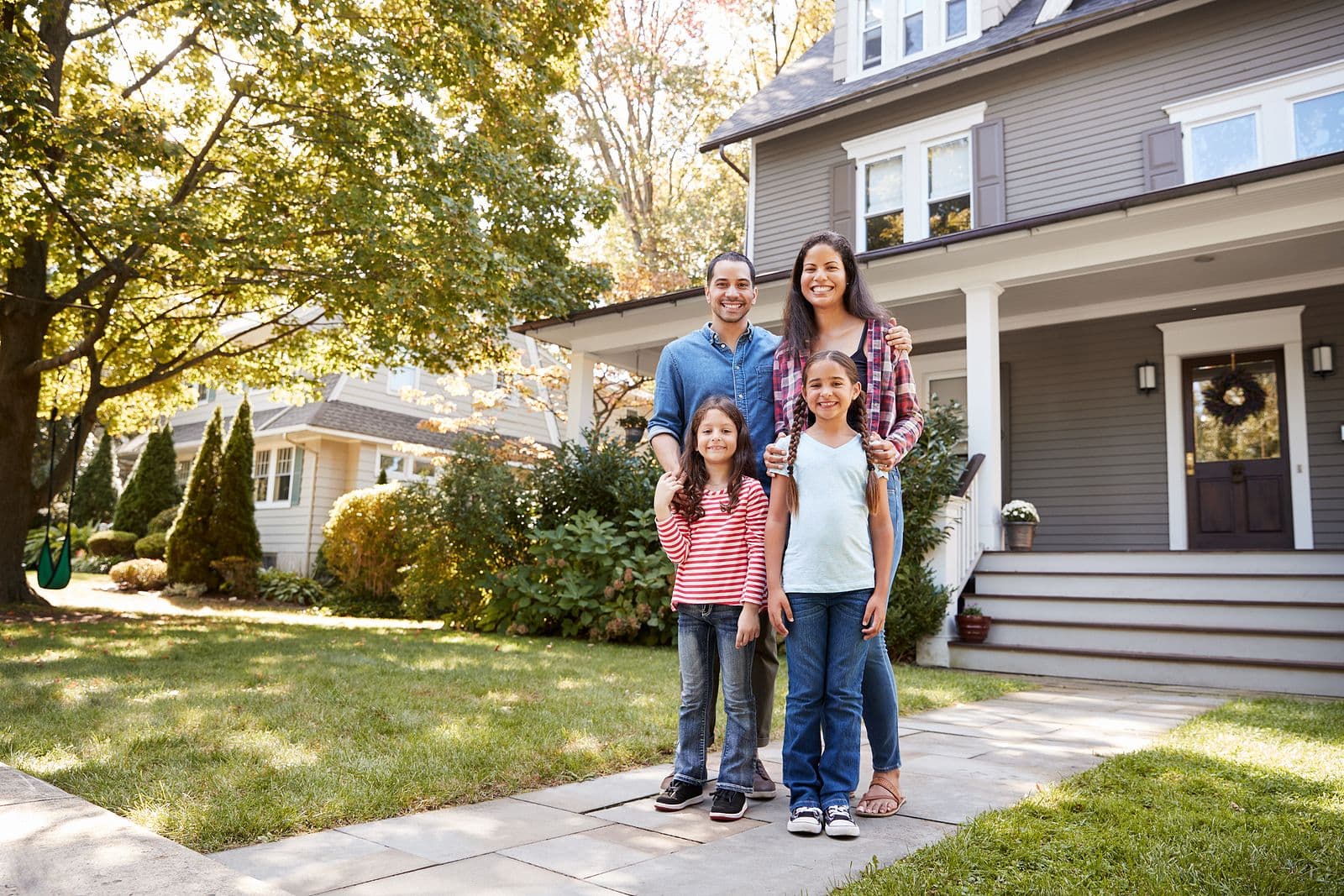 Family in front of house